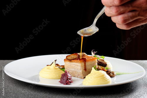 Plated freshly grilled pork belly with potato and mushrooms/fine dining