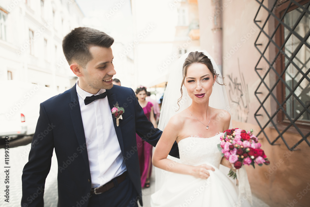 wedding couple is standing and kissing in the streets of old city wedding couple is standing and kissing in the streets of old city