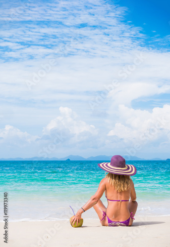 Fototapeta Naklejka Na Ścianę i Meble -  Cute woman relaxing on the beach