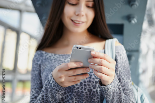Cute white girl using modern dual camera smart phone