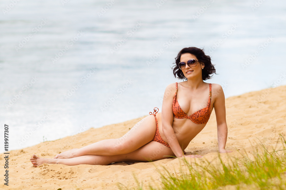 plump woman sunbathing on the beach plump woman sunbathing on the beach