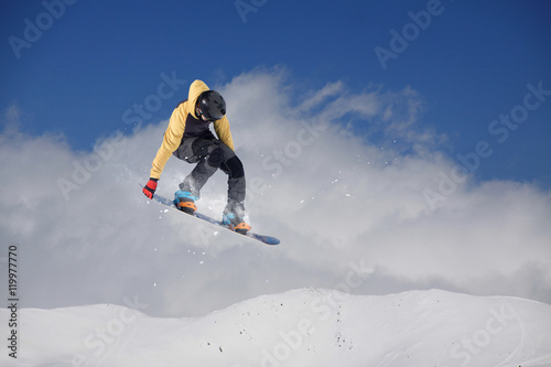 Snowboarder jumping on mountains. Extreme sport.