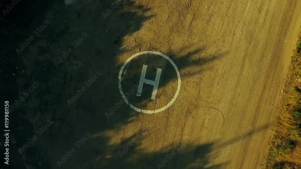 Aerial view on helipad, when helicopter is take off. Shoot from drone. Full HD video