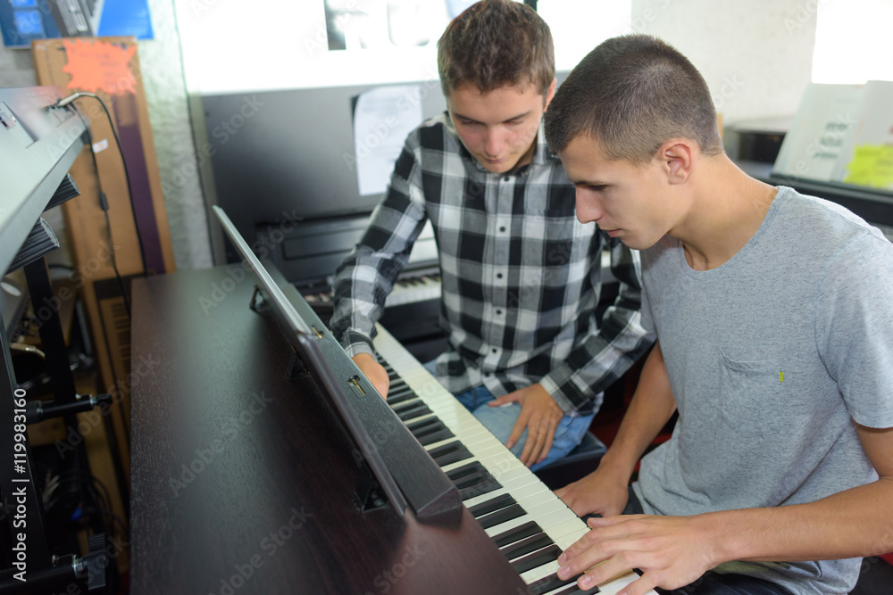 Obraz premium Two young men playing an organ