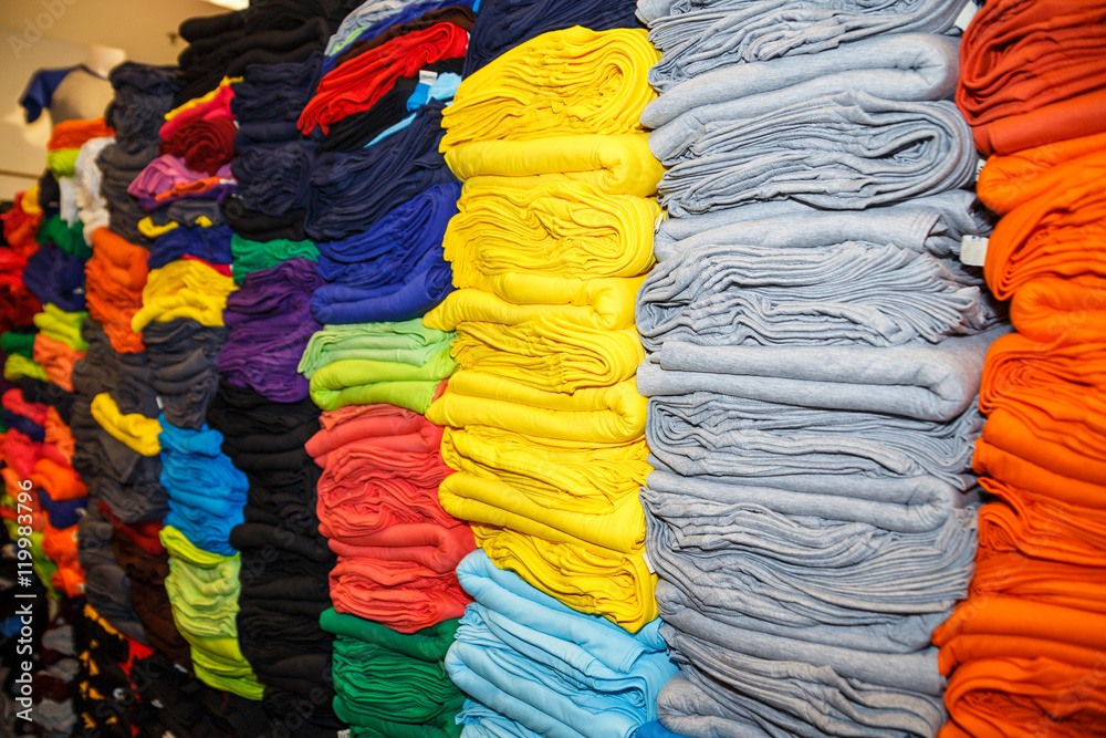 Pile of colorful clothes, stack of clothing in the store.