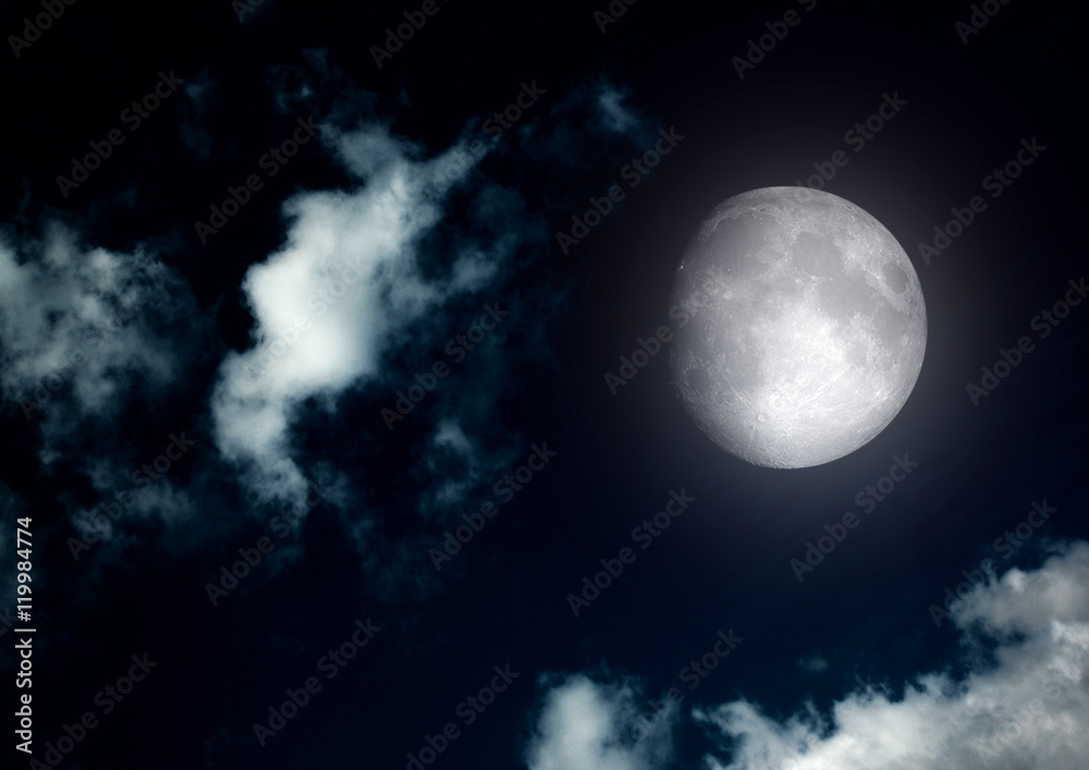 The moon in the night sky in clouds