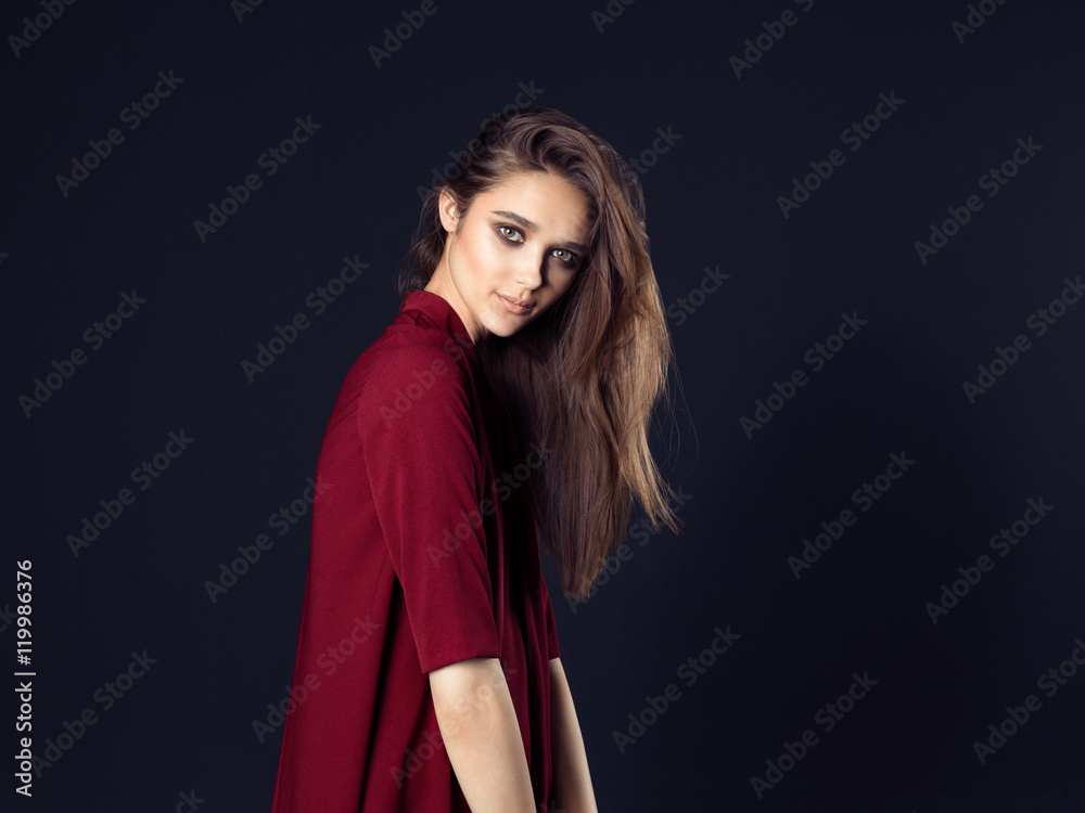 Fashion photo of young beautiful woman on black background.