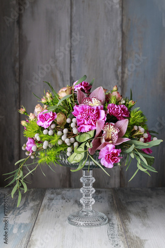Floral arrangement with orchids  carnations and brunia flowers