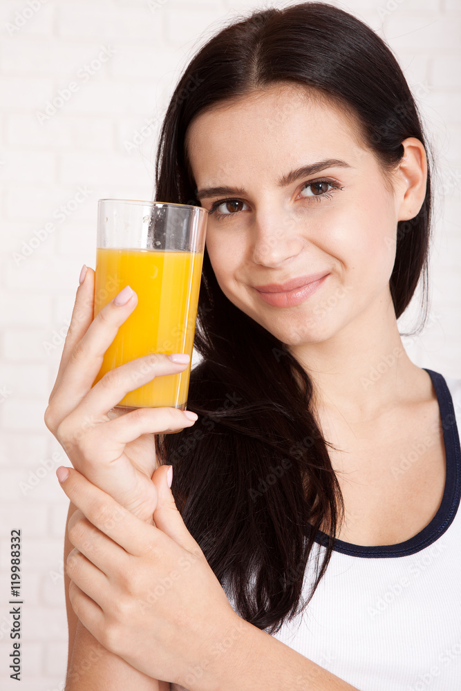 Woman drinking orange juice Beautiful mixed-race Asian, Caucasian model. Woman drinking orange juice Beautiful mixed-race Asian, Caucasian model.
