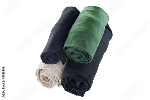 Fotografie Stack of rolled clothes, t-shirt, pants, black jeans isolated on white backgroun