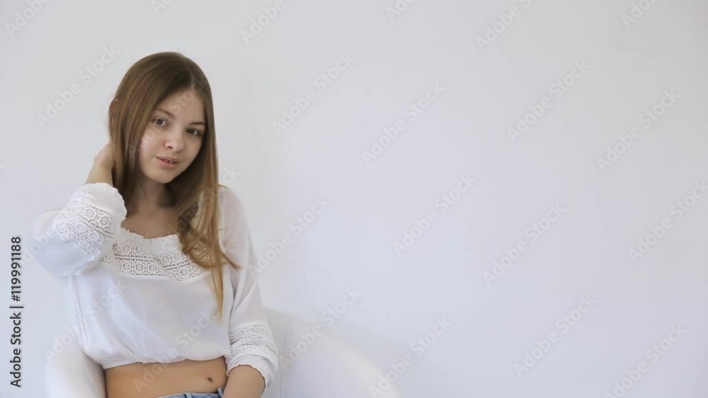 Young female is whirling posing sitting on swivel chair. Young female is whirling posing sitting on swivel chair.