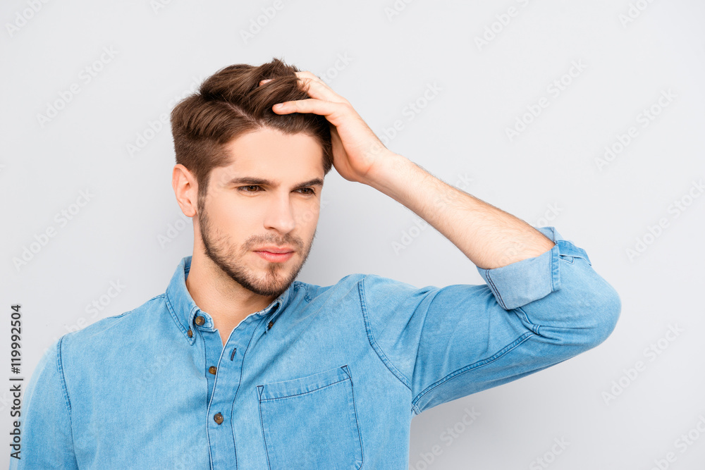 Portrait of handsome stylish young man touching his hair Portrait of handsome stylish young man touching his hair