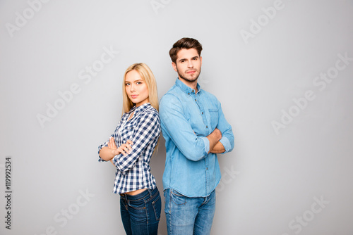 Man and woman in love with crossed hands on gray background