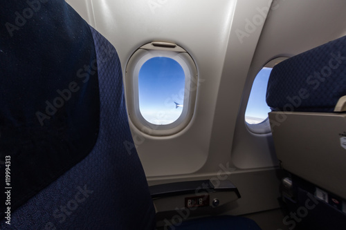 Airplane seat and window inside an aircraft.