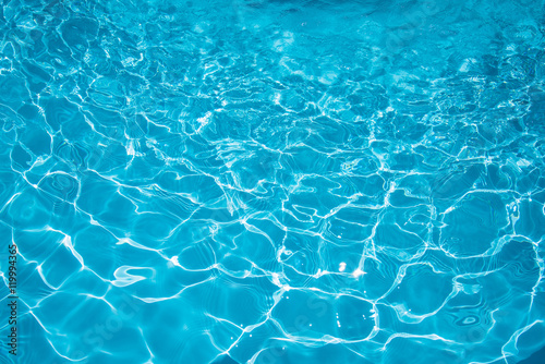 Ripple Water in swimming pool with sun reflection, Blue water abstract