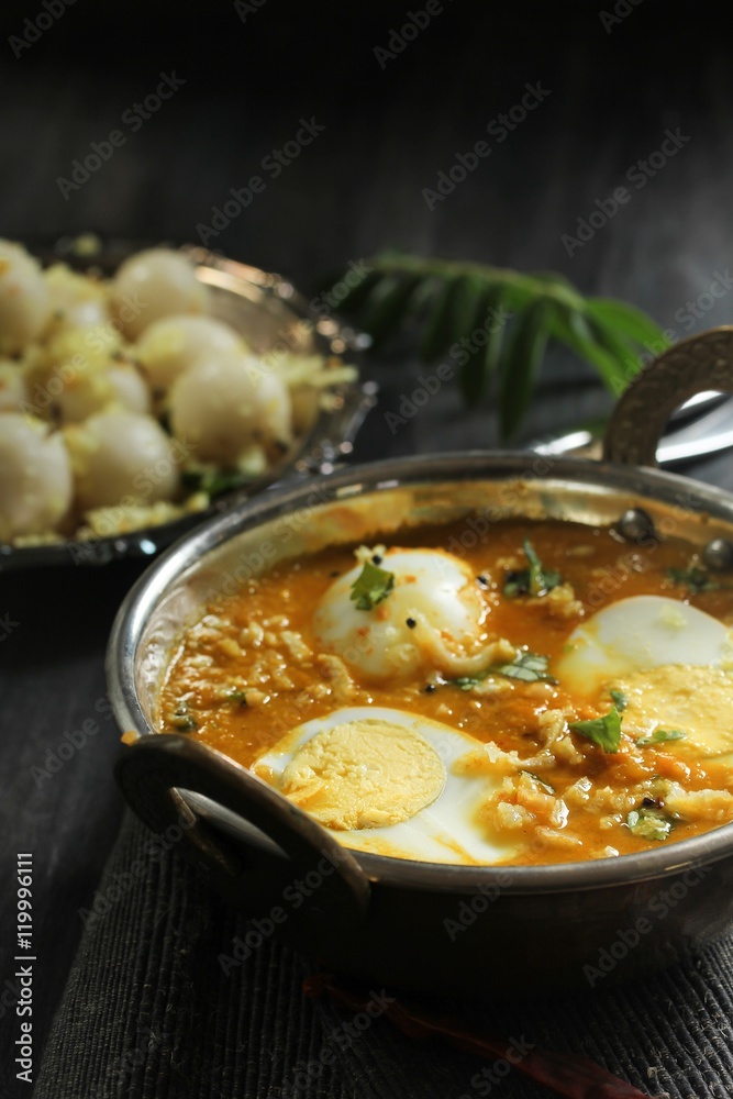 Egg curry served with steamed rice dumplings, selective focus