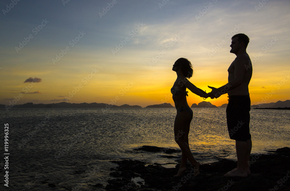 Silhouettes loving couple at sunset on the Philippine Islands