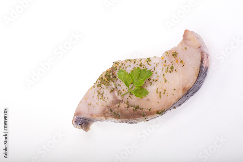 a piece of fish on a white background, photo studio, isolated, herbs, meal