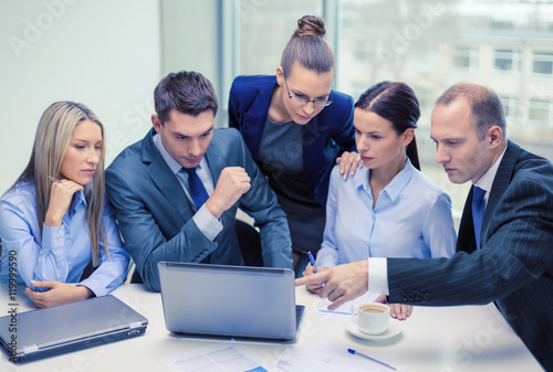 business team with laptop having discussion