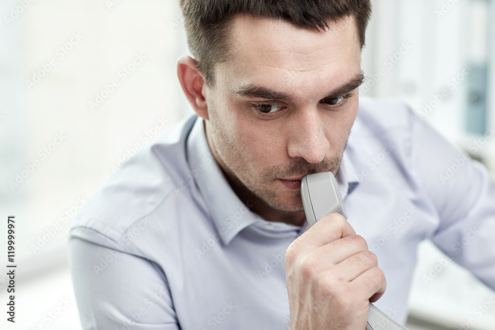 face of businessman with phone receiver in office face of businessman with phone receiver in office