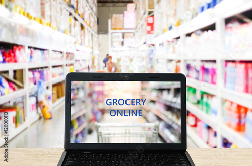 Grocery online on labtop screen over blur supermarket background