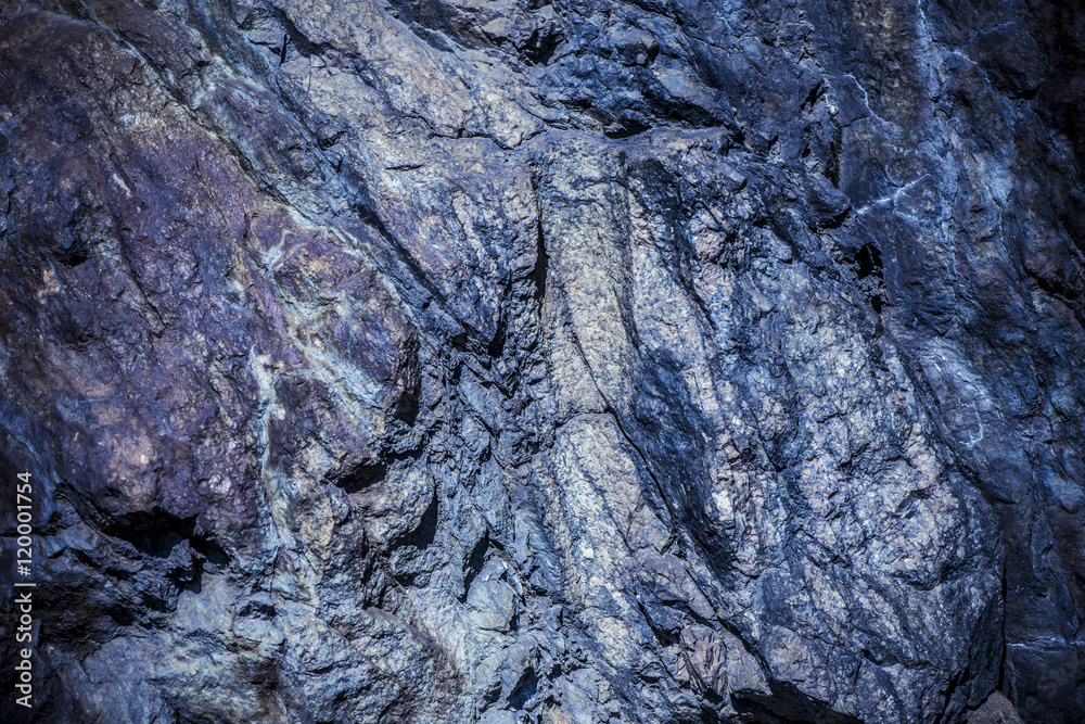 Fototapeta premium Stone background, rock wall backdrop with rough texture. Abstract, grungy and textured surface of stone material. Nature detail of rocks.