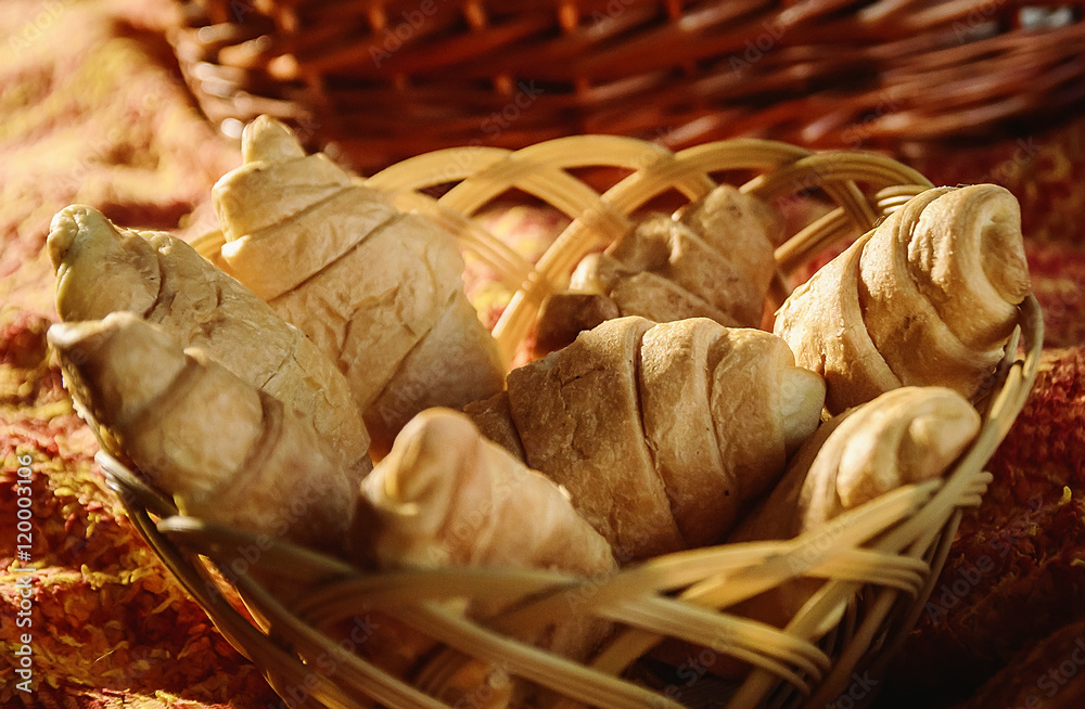 fresh croissants in a wicker basket