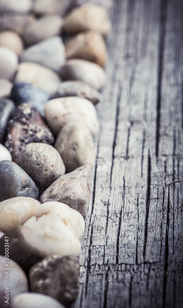 Stones on wooden background, concept of harmony and tranquility. Decoration with stone pebbles as natural design backdrop with copy space. Stones on wooden background, concept of harmony and tranquility. Decoration with stone pebbles as natural design backdrop with copy space.