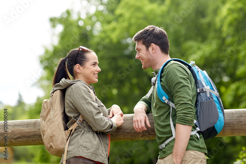 smiling couple with backpacks in nature © Syda Productions