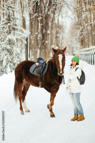 beautiful girl and horse in winter