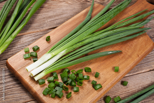 Fresh green onions on a cutting board