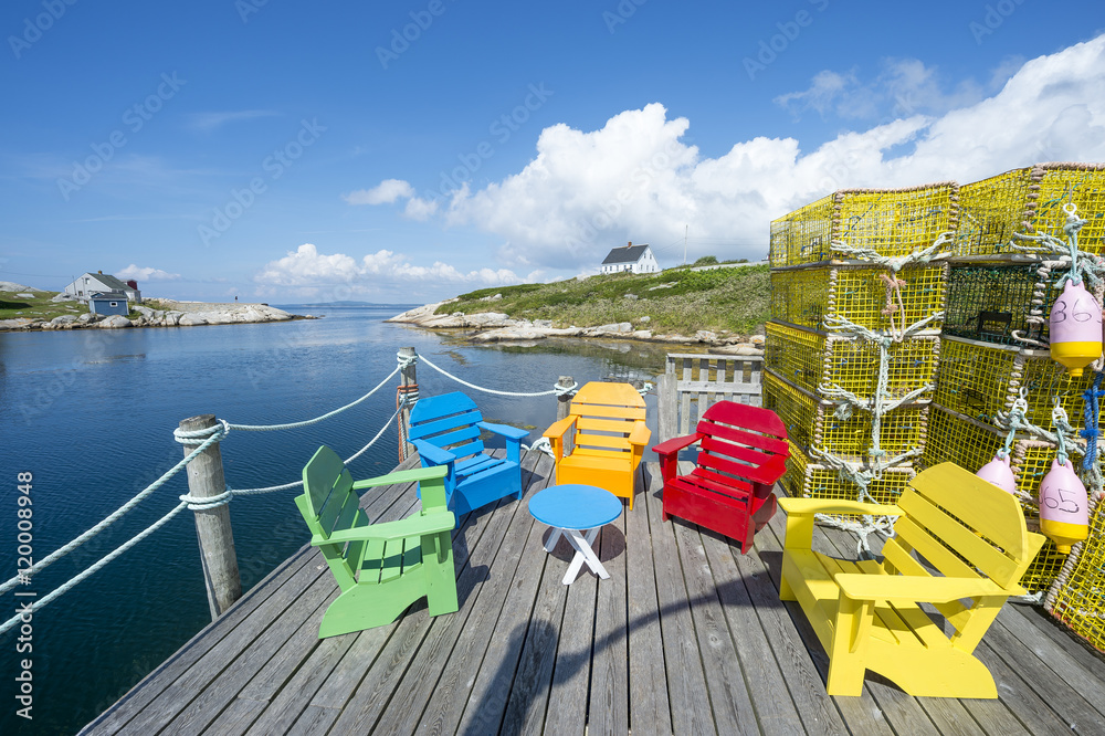 Brightly colored Adirondack chairs sit next to stacks of lobster