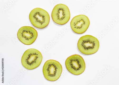 Circle of sliced kiwi on white background. Arrow point to the center space.