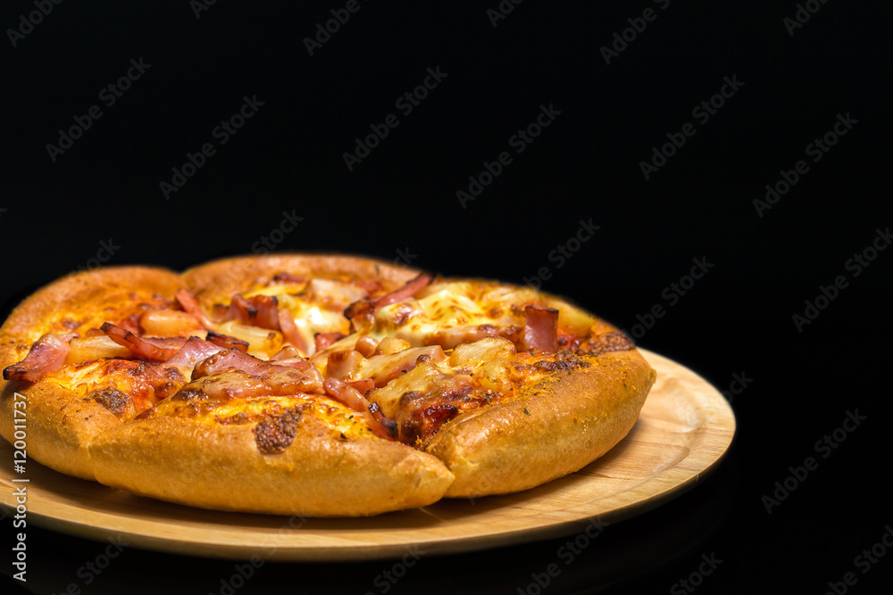 Hawaiian pizza on a wooden tray. Hawaiian pizza on a wooden tray.