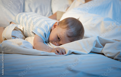 Toned image of adorable baby sleeping on big pillow at late even © Кирилл Рыжов