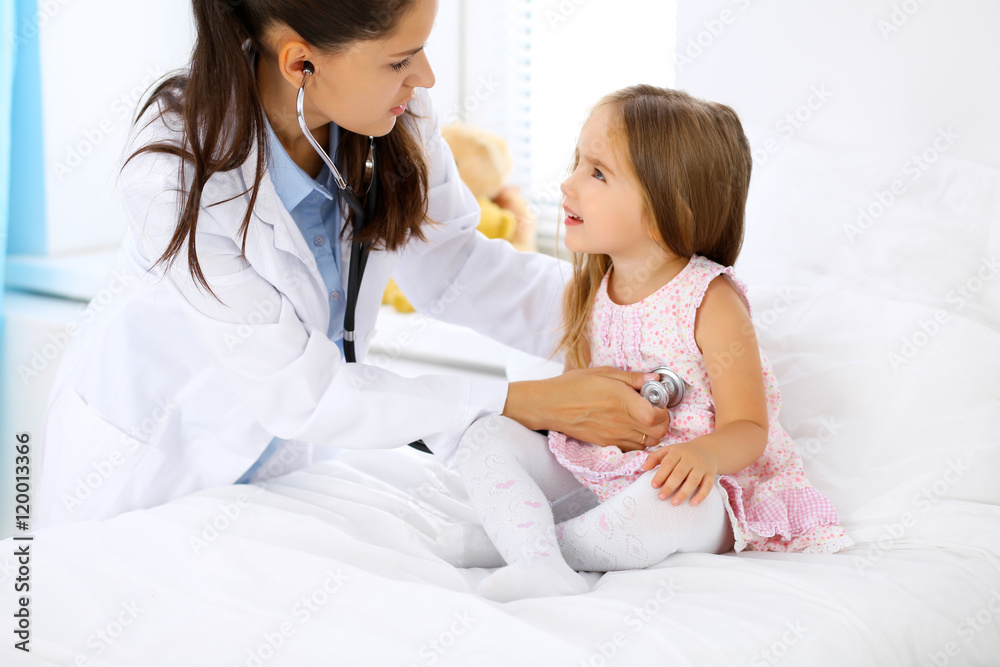 Doctor examining a little girl by stethoscope Doctor examining a little girl by stethoscope