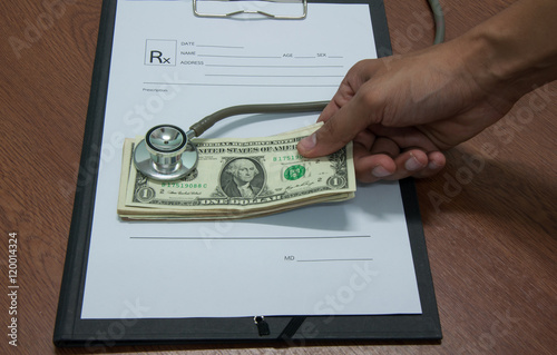 Stethoscope and money symbol for health care costs photo