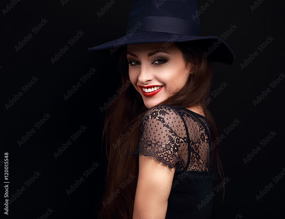 Happy makeup woman in fashion blue hat smiling toothy on dark bl Happy makeup woman in fashion blue hat smiling toothy on dark bl