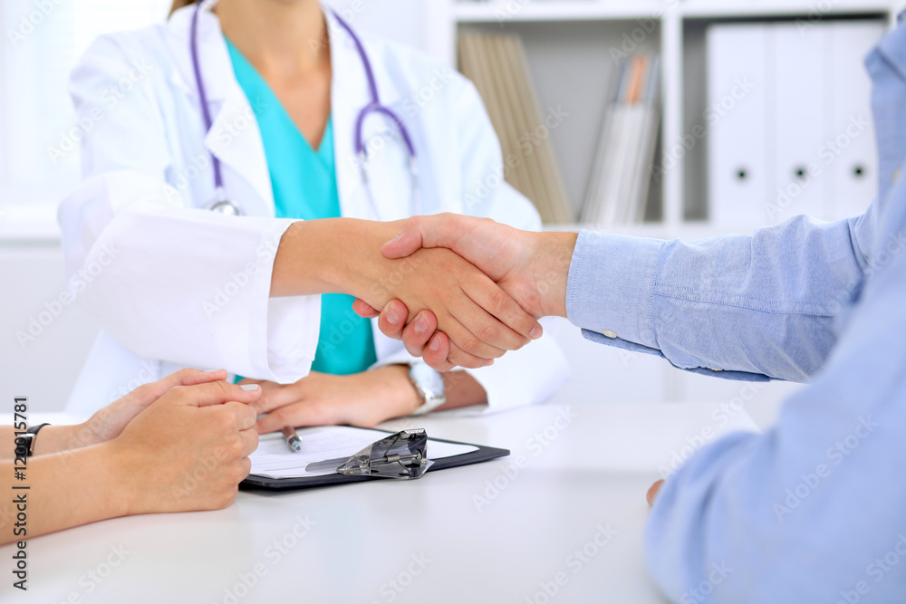 Doctor and patient are shaking hands Doctor and patient are shaking hands