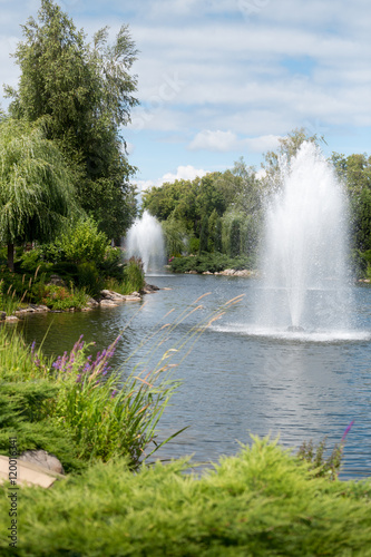 Landscape of fountains in pond at formal garden