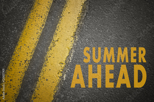 Summer concept. Summer ahead written on road.