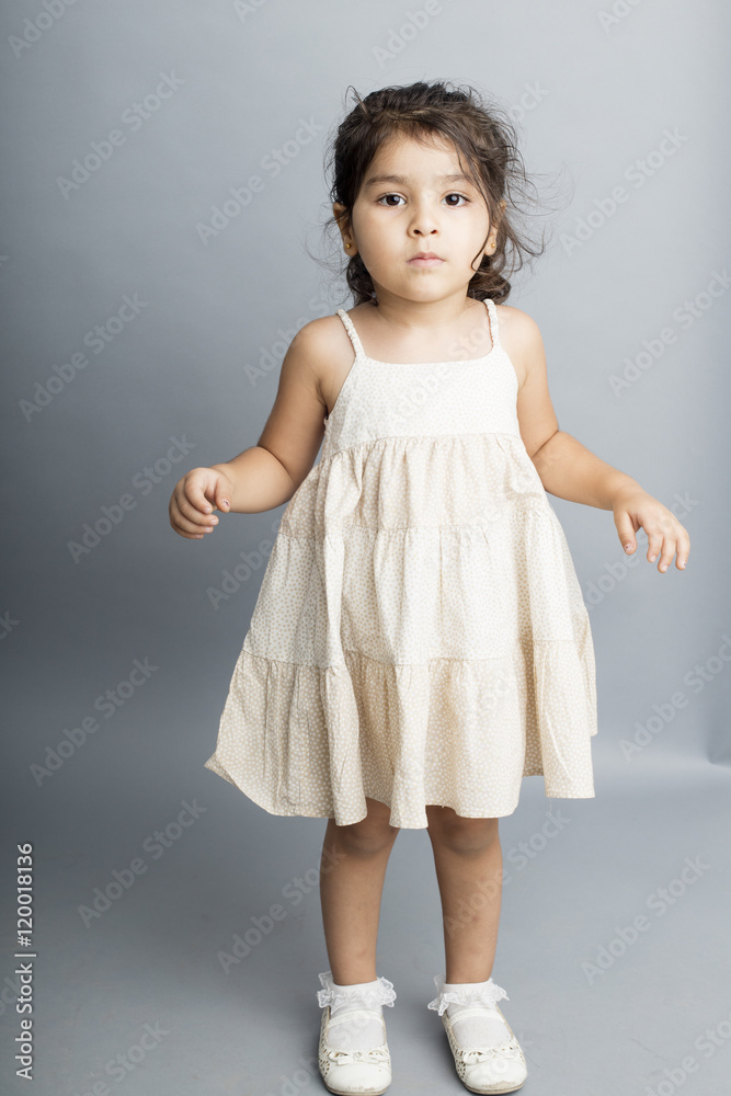 Small girl playing and posing isoated inside studio Small girl playing and posing isoated inside studio
