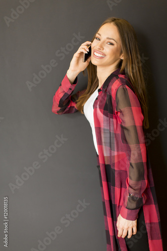 Young woman by black wall