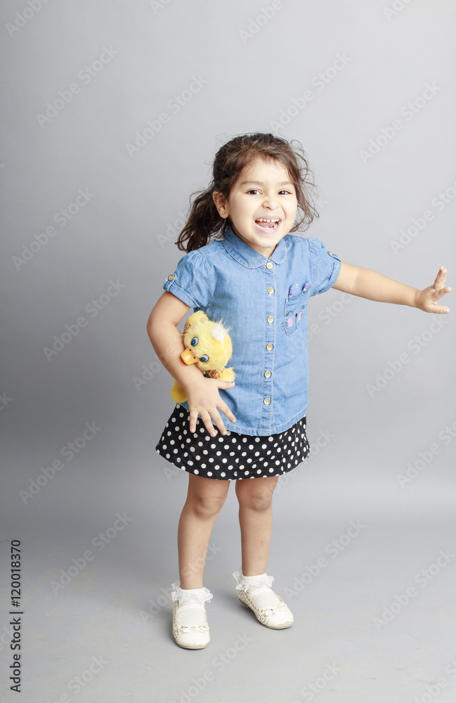 Small girl playing and posing isoated inside studio Small girl playing and posing isoated inside studio