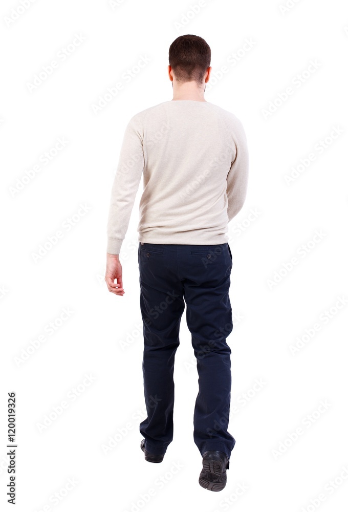 Back view of walking businessman. bearded man in a white warm sweater goes away.