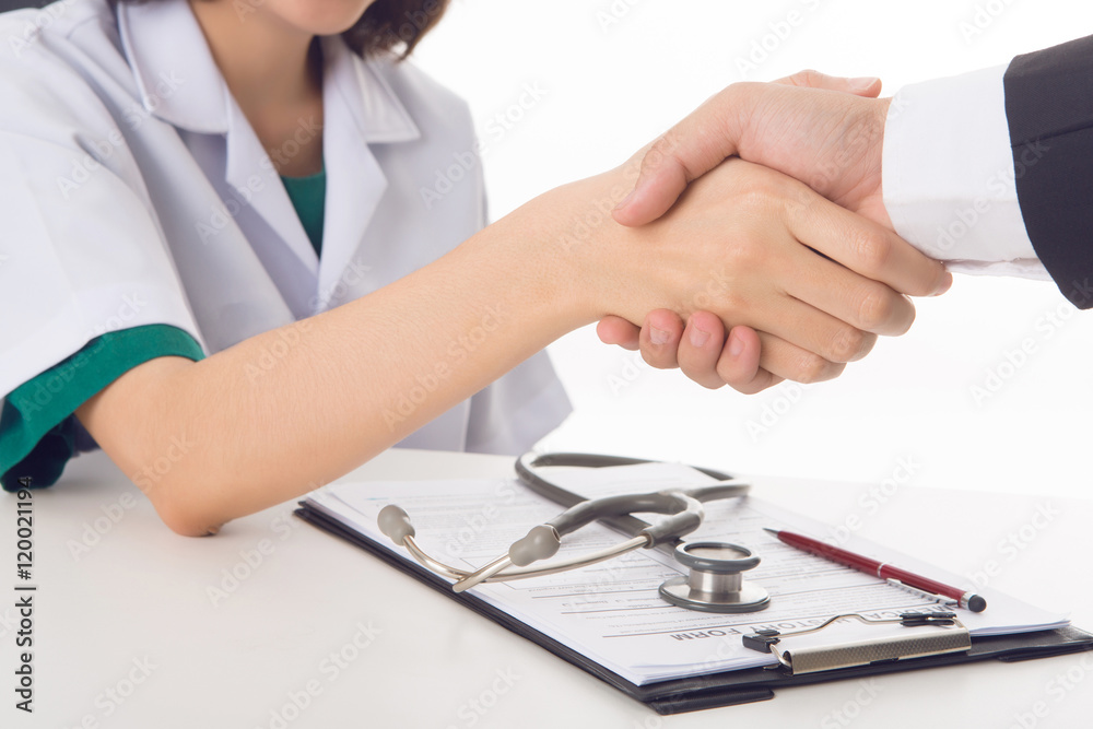 Woman doctor shaking hand with businessman Woman doctor shaking hand with businessman