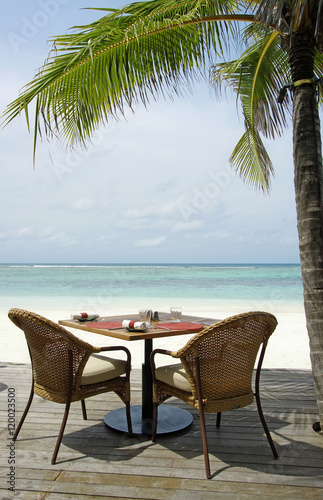 table setting at tropical restaurant on the beach