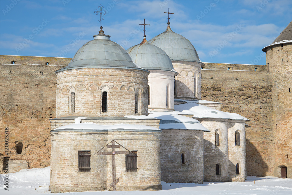 Two medieval churches of Ivangorod fortress closeup sunny march afternoon. Leningrad region