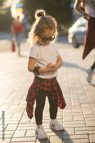Stylish funny hipster little girl on street