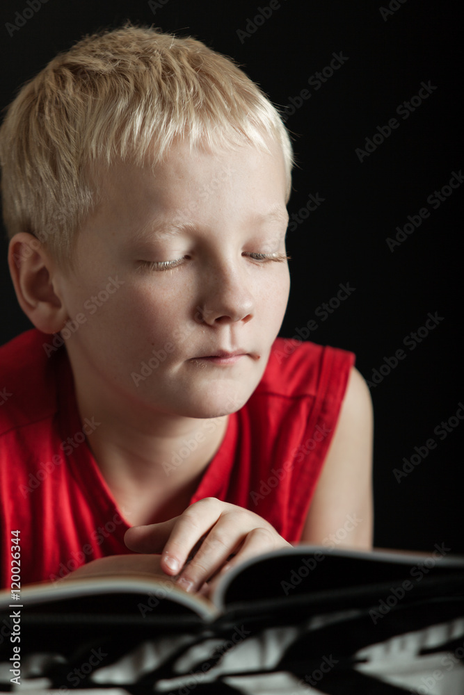 Cute blond boy reading book Cute blond boy reading book